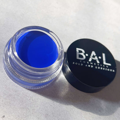 Gel Eyeliner Pot that is Royal Blue in color inside a glass pot. the Logo for Bold and Luscious Cosmetics is visible on the lid. The texture is soft and creamy.
