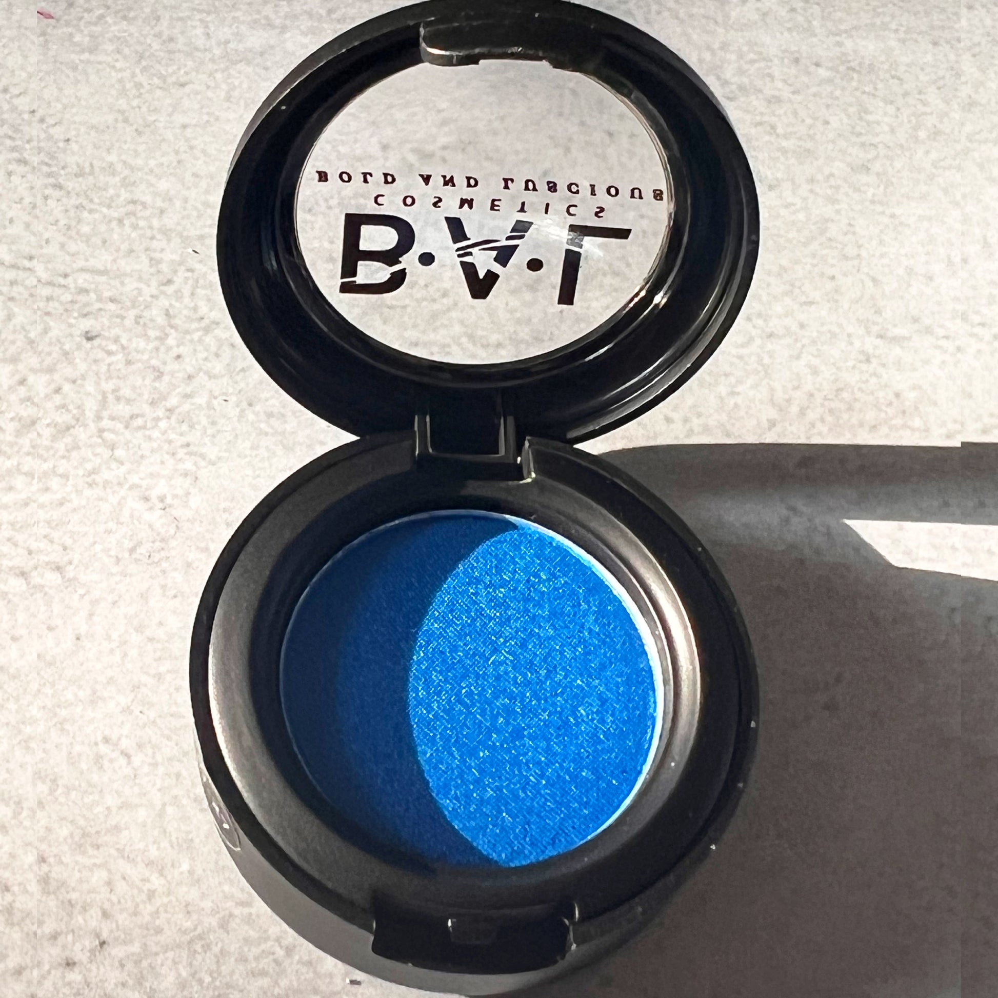 A deep rich blue color that is shimmery and pigmented. the Bold and Luscious Logo is visible.