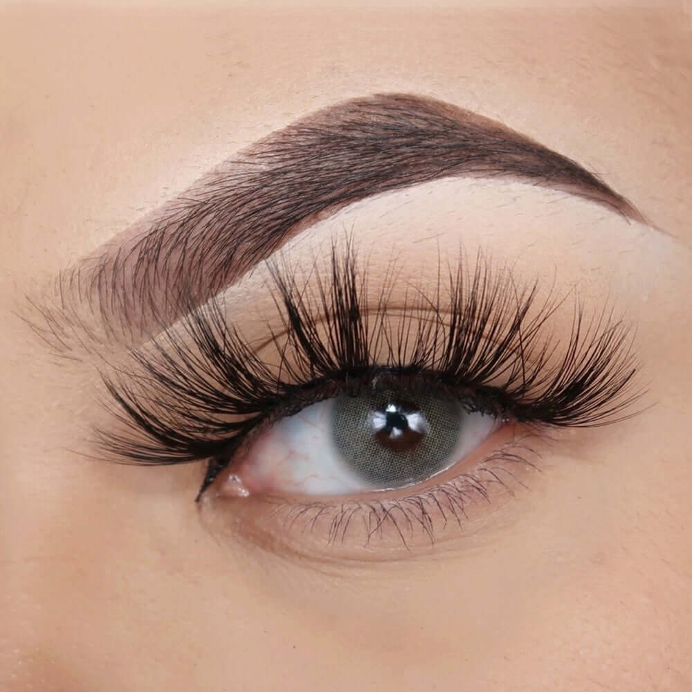 A close up of an eye with long, dramatic lashes that are separated in a way which make the eye appear wide. This style is 25mm.
