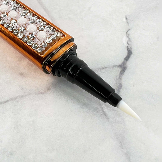 Bold and Luscious Brand Diamond Status Magic Lash is an Adhesive Eyeliner pen. The ink in this pen is Clear. in this picture, you see the fine tip making it easy to apply like traditional eyeliner then apply your lashes directly to the liner.