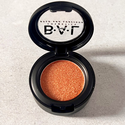 A burnt terracotta color single pan shadow. the bold and luscious logo is visible