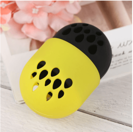 In this picture is a yellow and black beauty sponge holder. Store your beauty blender in this handy silicone container. it contains ventilation holes to allow your sponge to dry and breathe. Silicone is easy to wipe down and clean. 